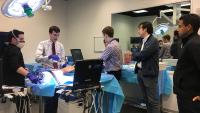 Rheumatology fellows observe sim center demonstration.